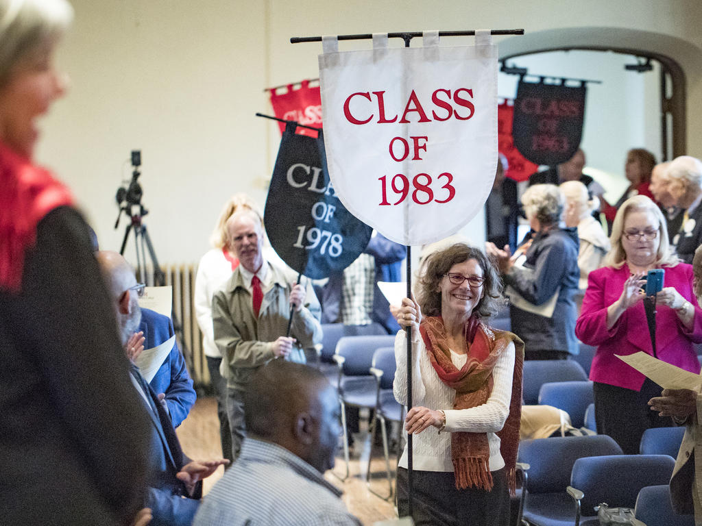 woman carrying class banner