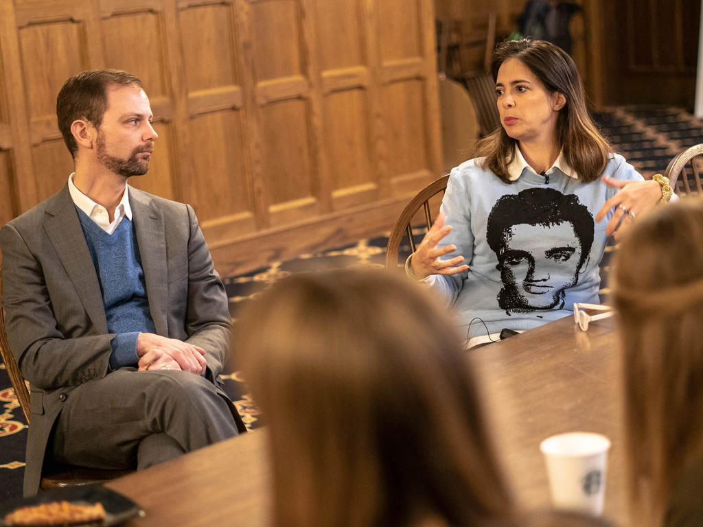 people at a table engaging in a conversation