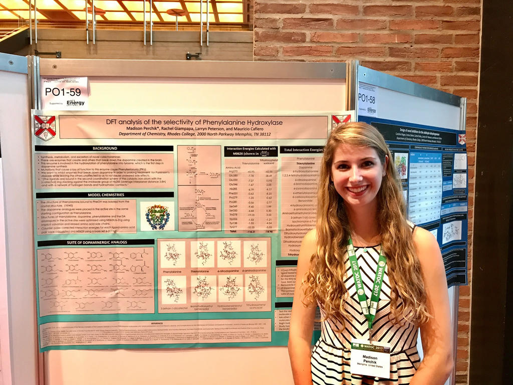 college student standing in front of a poster