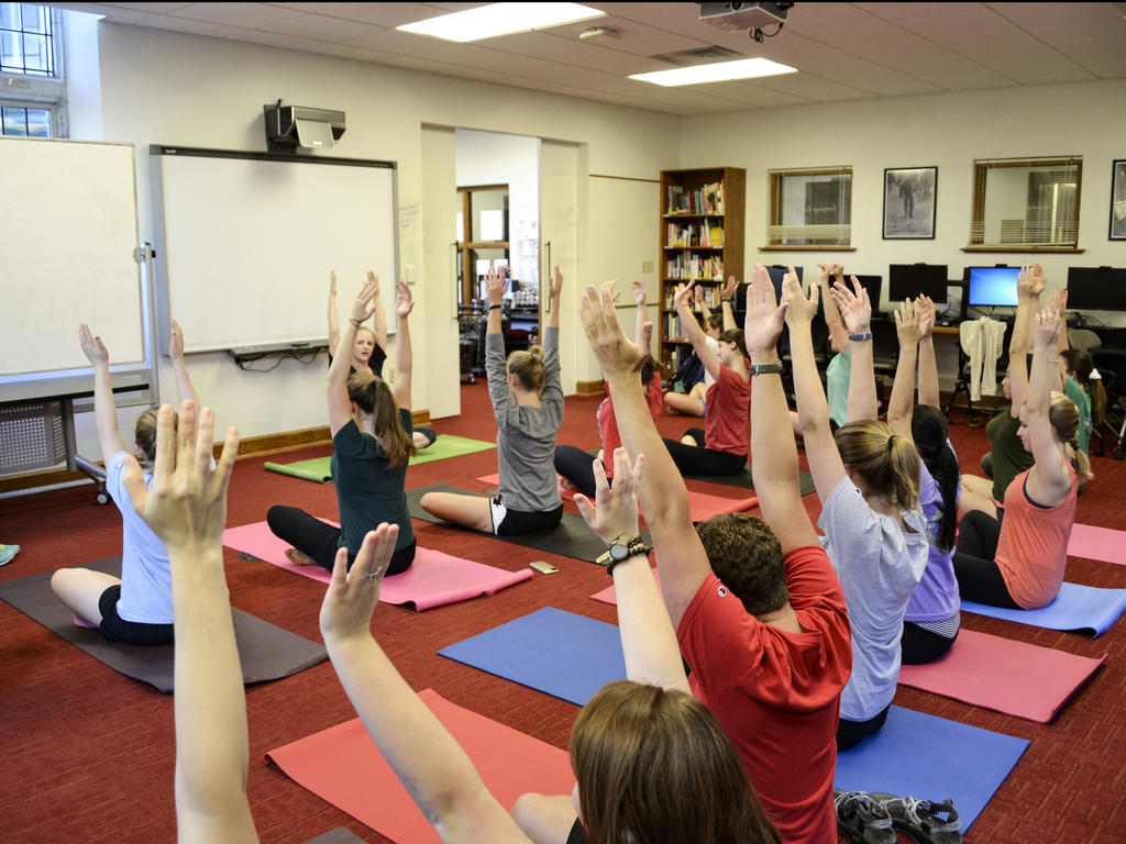 a teacher leadds a yhoga class