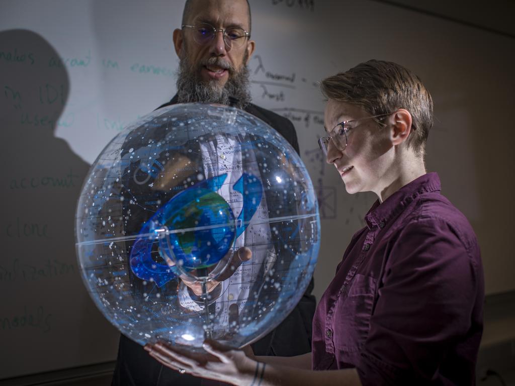 professor and student with globe