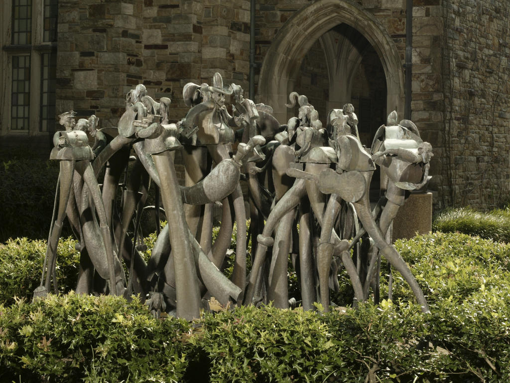 a group of bronze figures depicting campus life