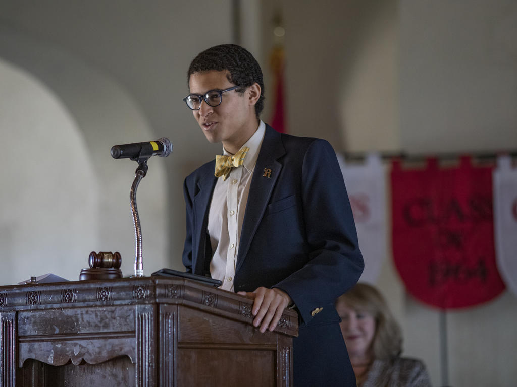 A student speaking at a podium 