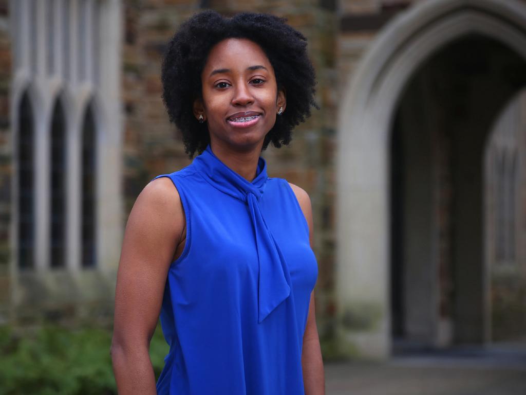 a young African American woman in a blue blouse