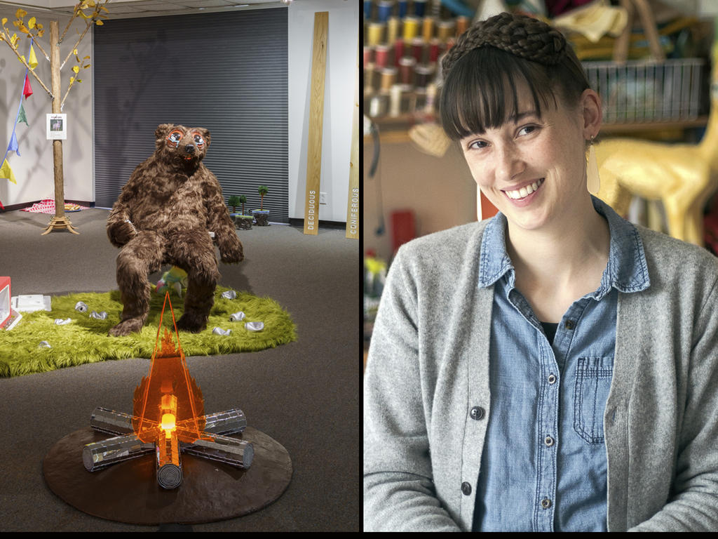 a young woman artist featured with a sculpture of a bear