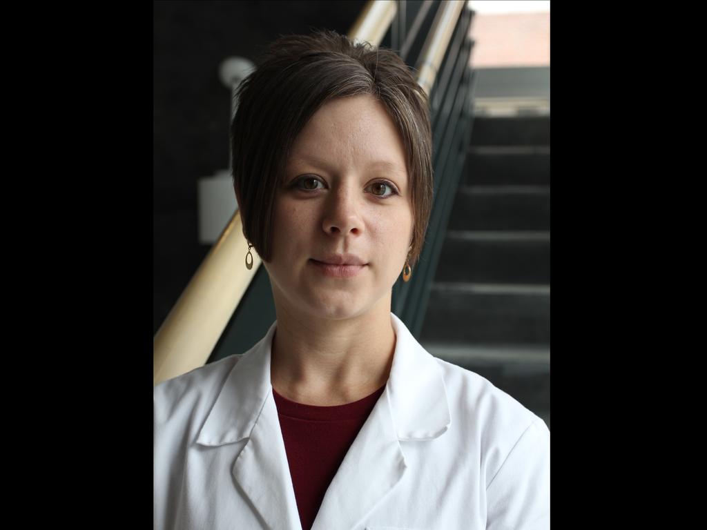 head and shoulder image of biology professor Elaine Frawley in white lab coat