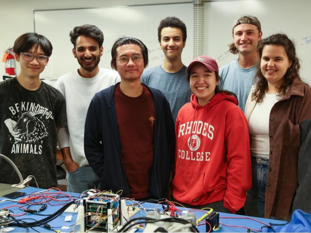 group image of Rhodes College students displaying cube satellite they've been working on