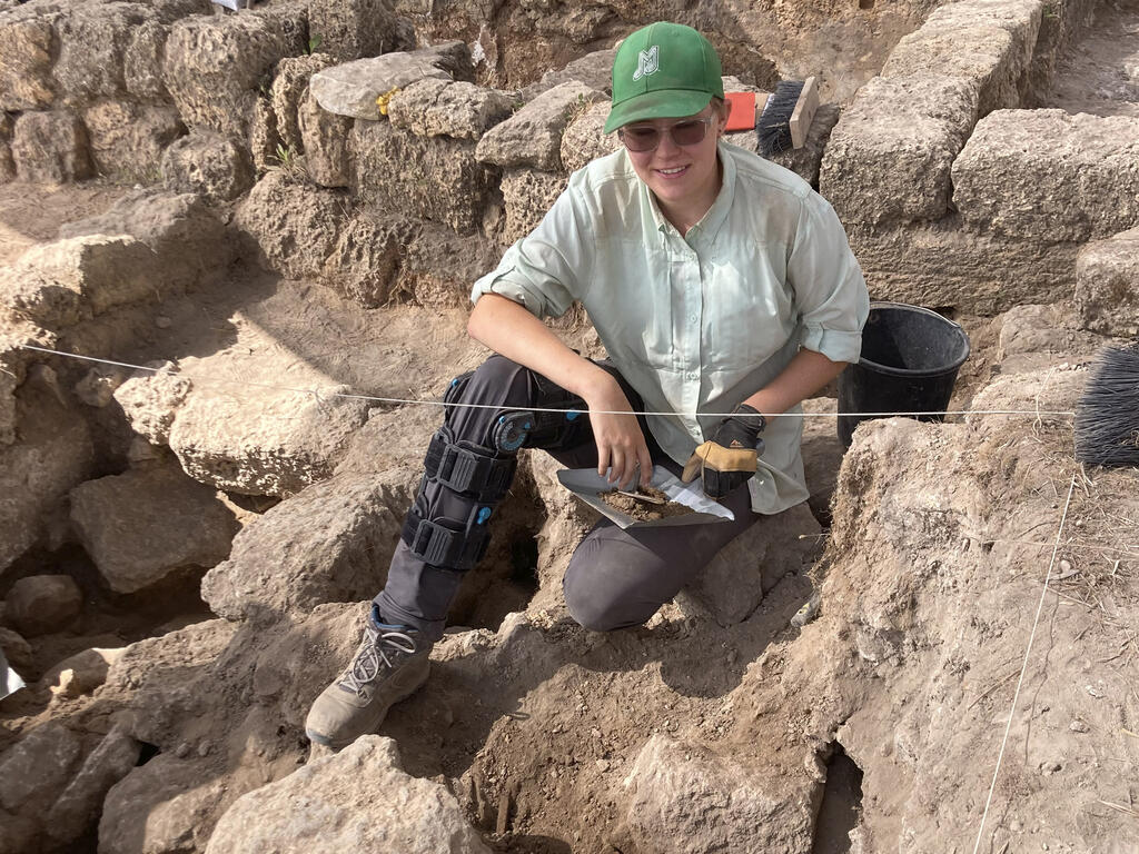 a student works among ancient ruins