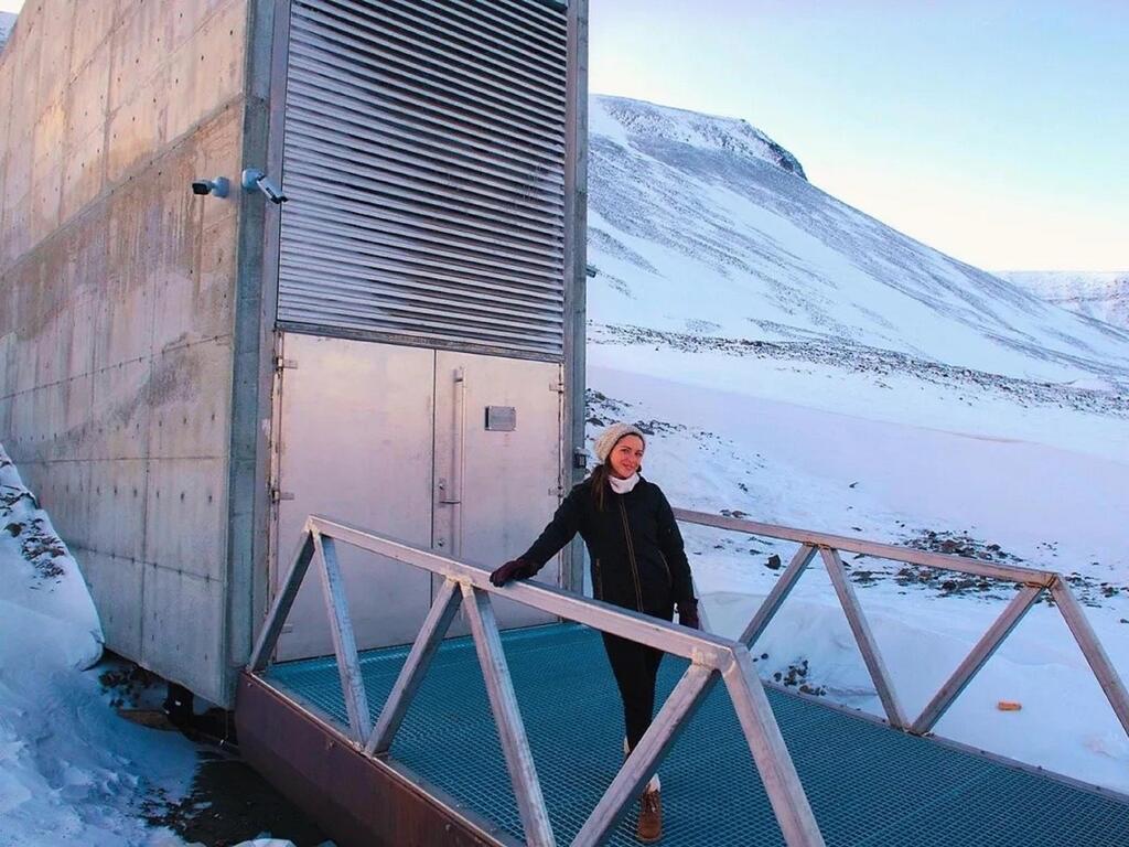 image of Rhodes College alumna standing in front of Svalbard Global Seed Vault