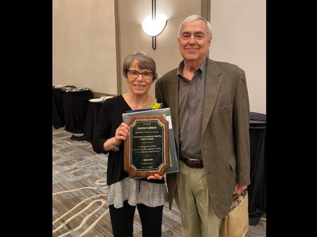 image of Lucia Colbert holding a plaque, standing next to her husband