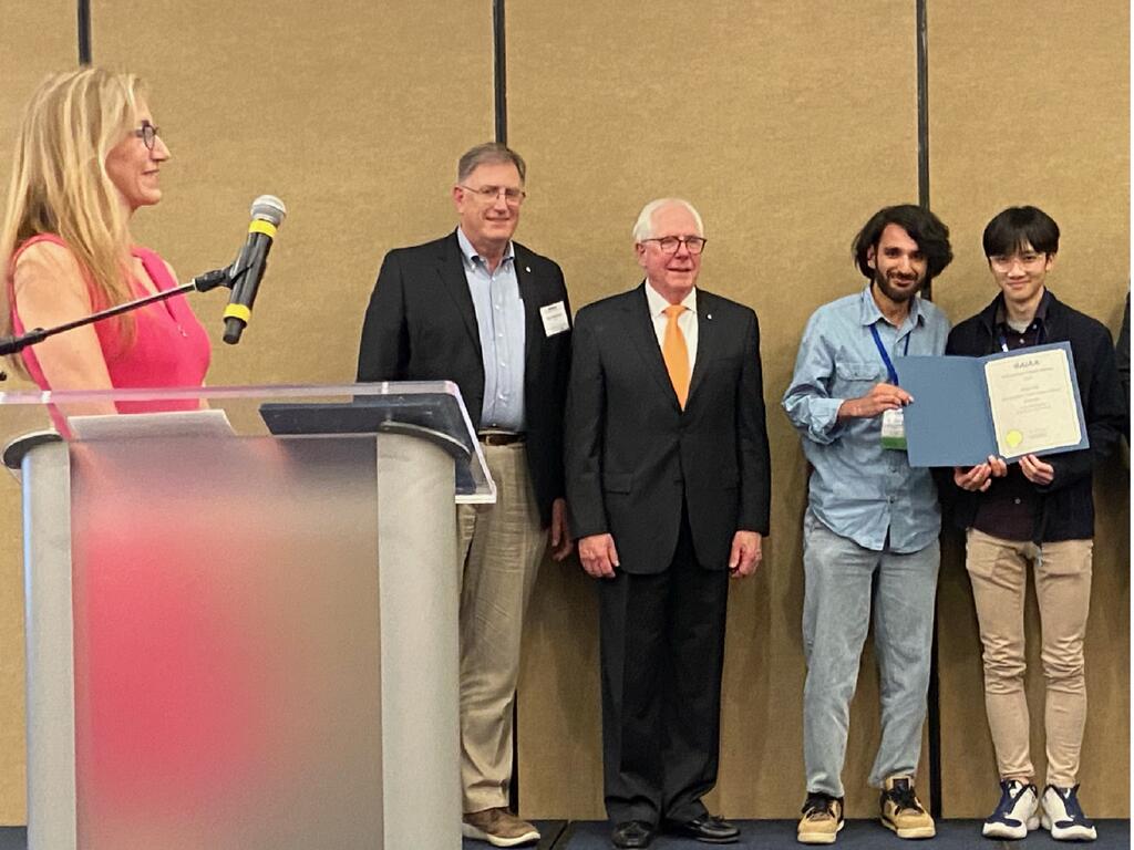 Rhodes College Students accepting a prize at a conference