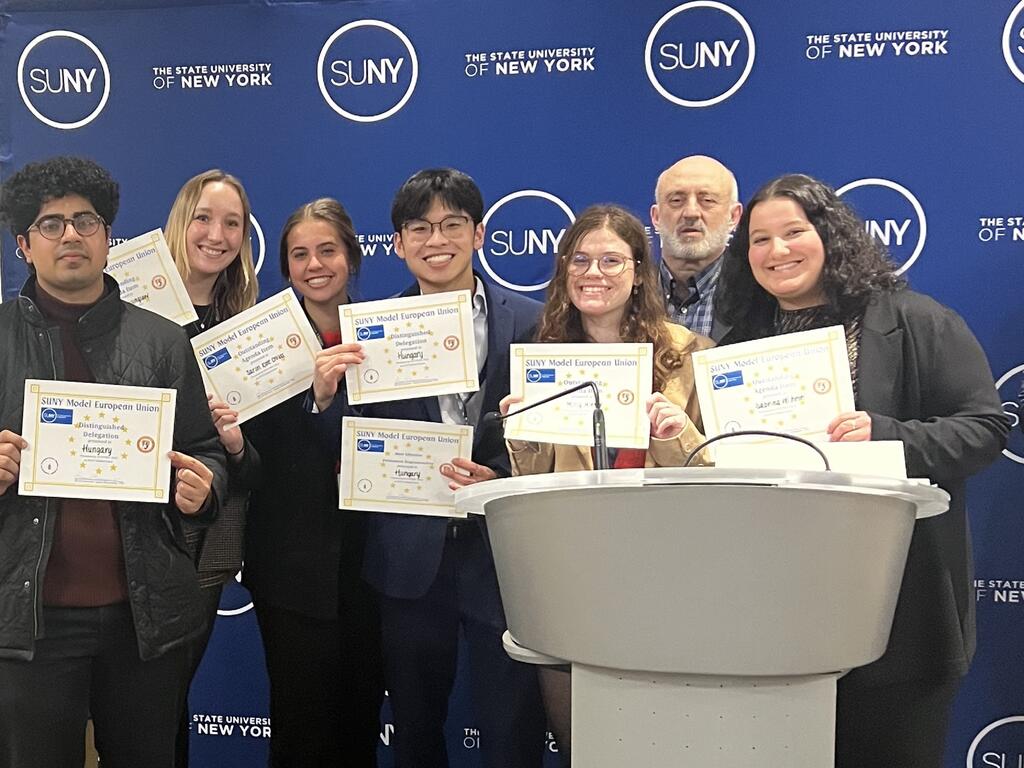 image of Rhodes College group each holding certificates