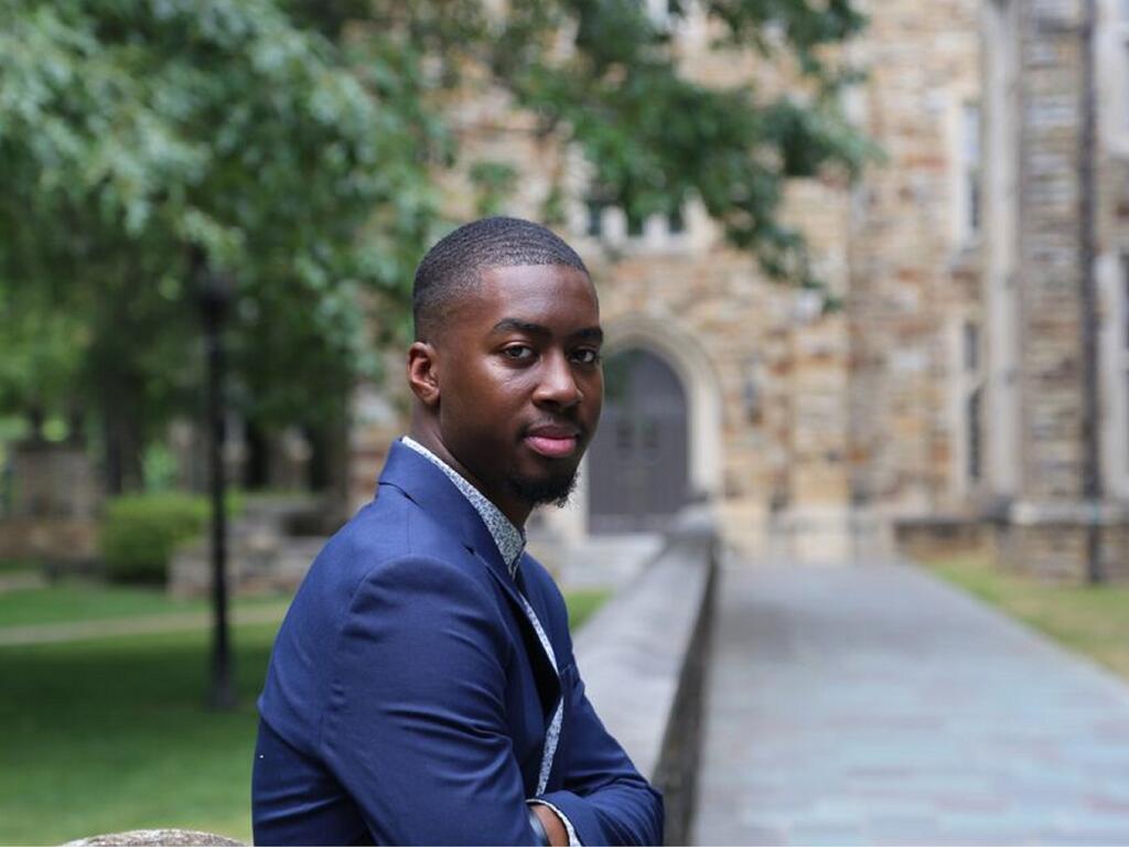 image of Landon Fulton sitting outside on Rhodes College campus