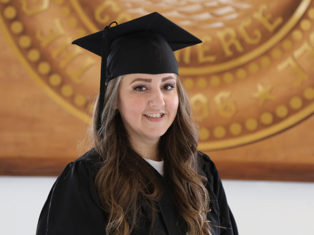 a young woman in graduation regalia