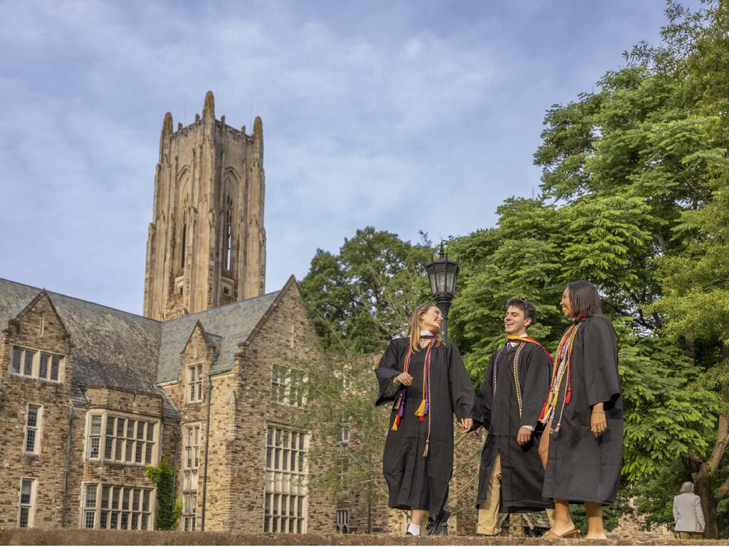 image of three Rhodes College graduates walking on campus