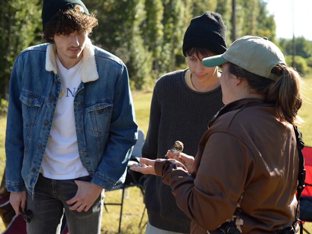 Rhodes College group discussing the journey of an ovenbird