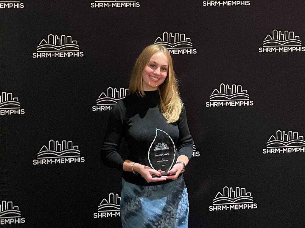 image of Sophia Comrie holding a trophy