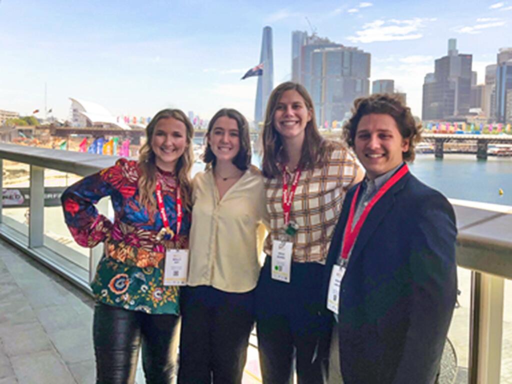 image of four Rhodes College students standing on a bridge