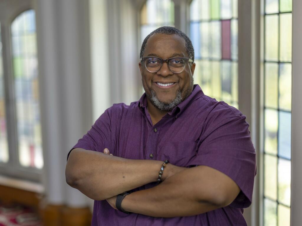 image of Charles McKinney standing in front of a window