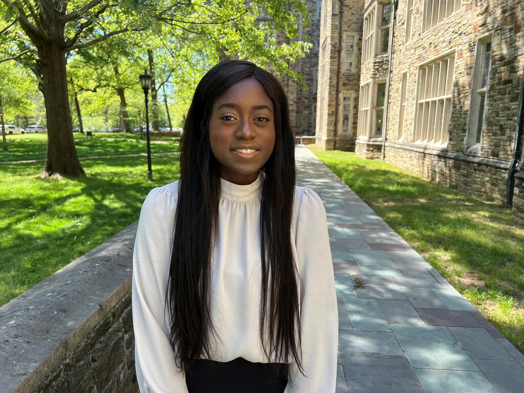 image of student Jannelle Bannor siting outside on college campus