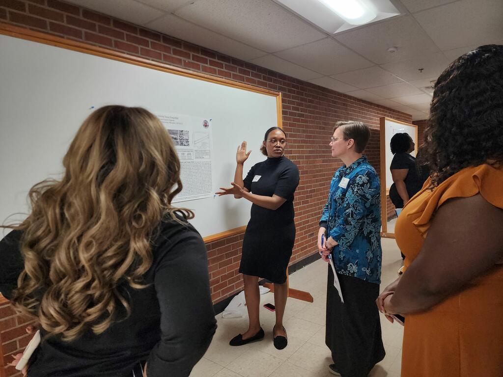 image of Kathryn Edwards at a poster board discussing her work