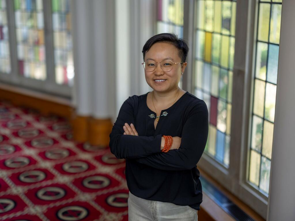 image of Shaolu Yu standing in front of a large window