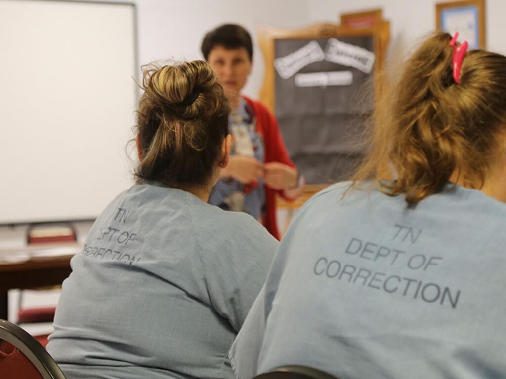 image of students listening to teacher in a classroom