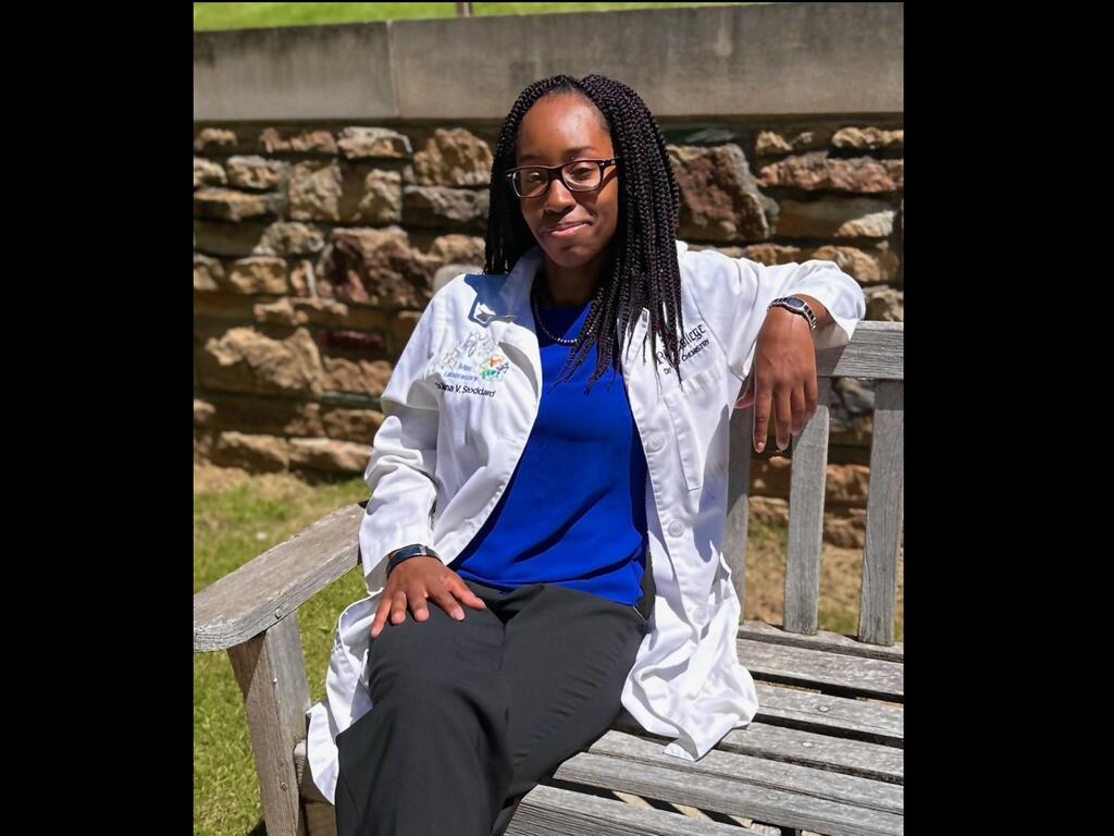 image of Shana Stoddard sitting on a bench on campus