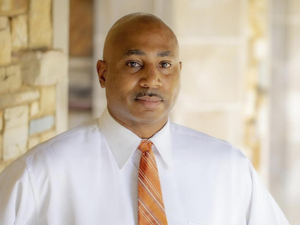  an African American man with a moustache dressed in a white shirt and tie