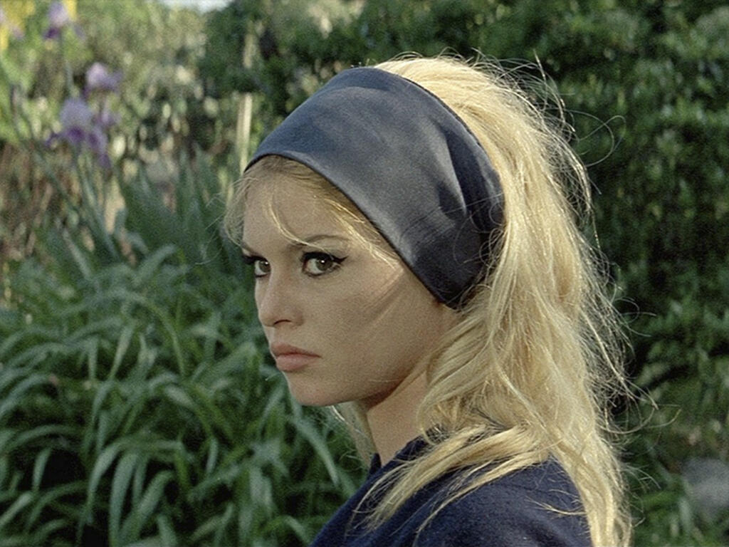 image of a woman wearing a head band, in a garden