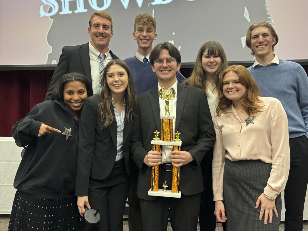 image of group of students with a trophy