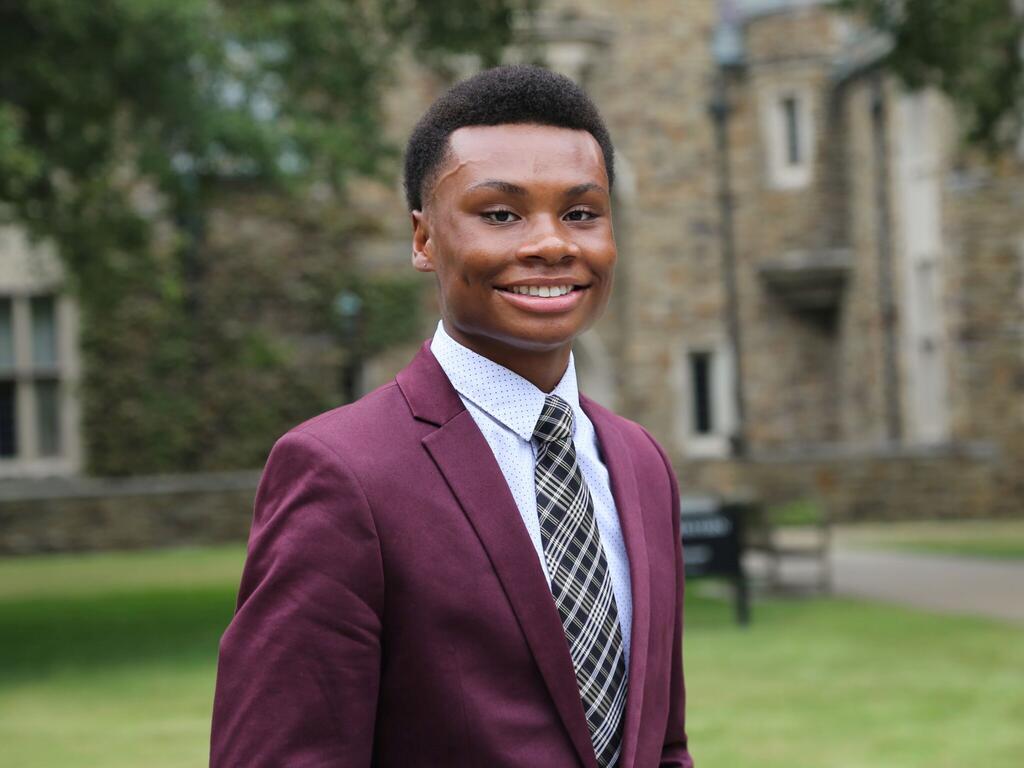 image of student Johnathan Burch standing outside on the Rhodes campus