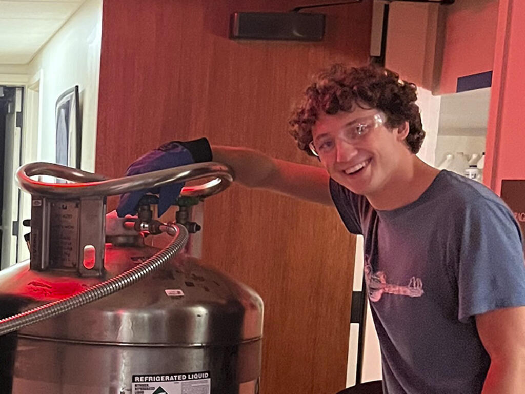 a young man with glasses and curly hair