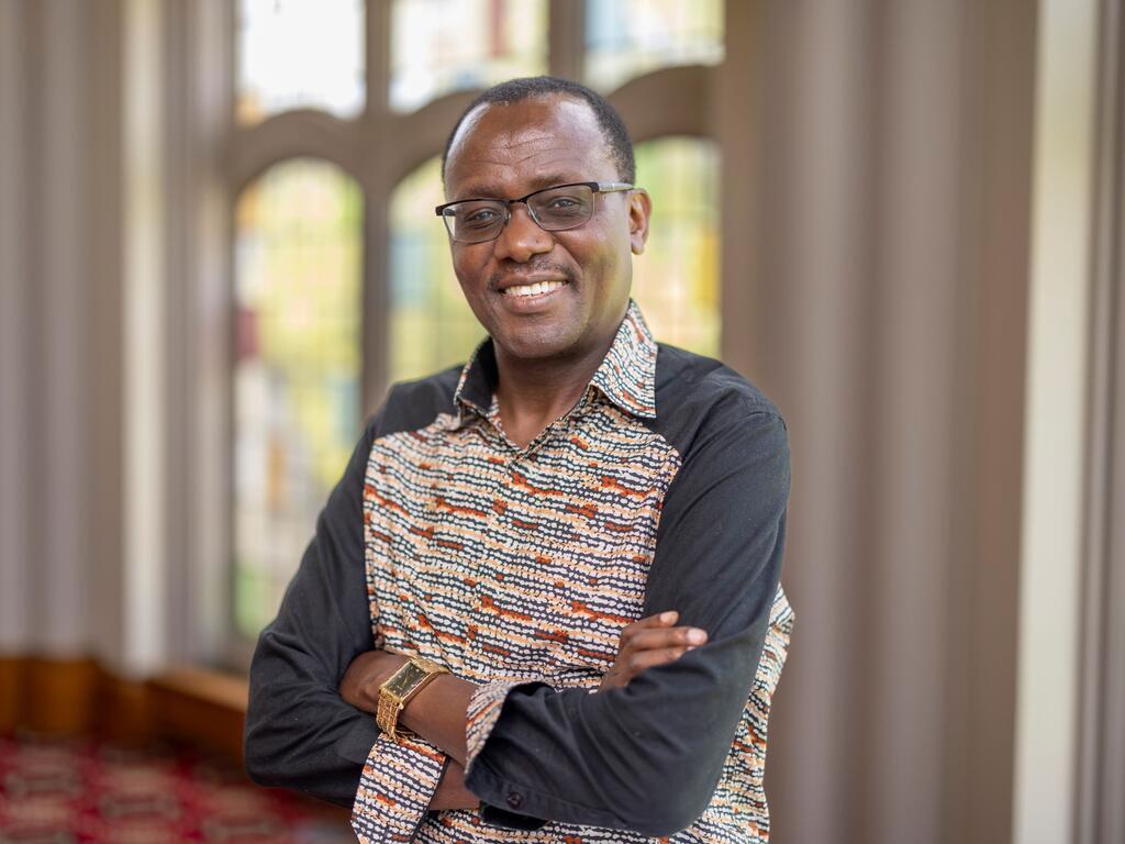 image of Shadrack Nasong’o standing in front of a stained glass window