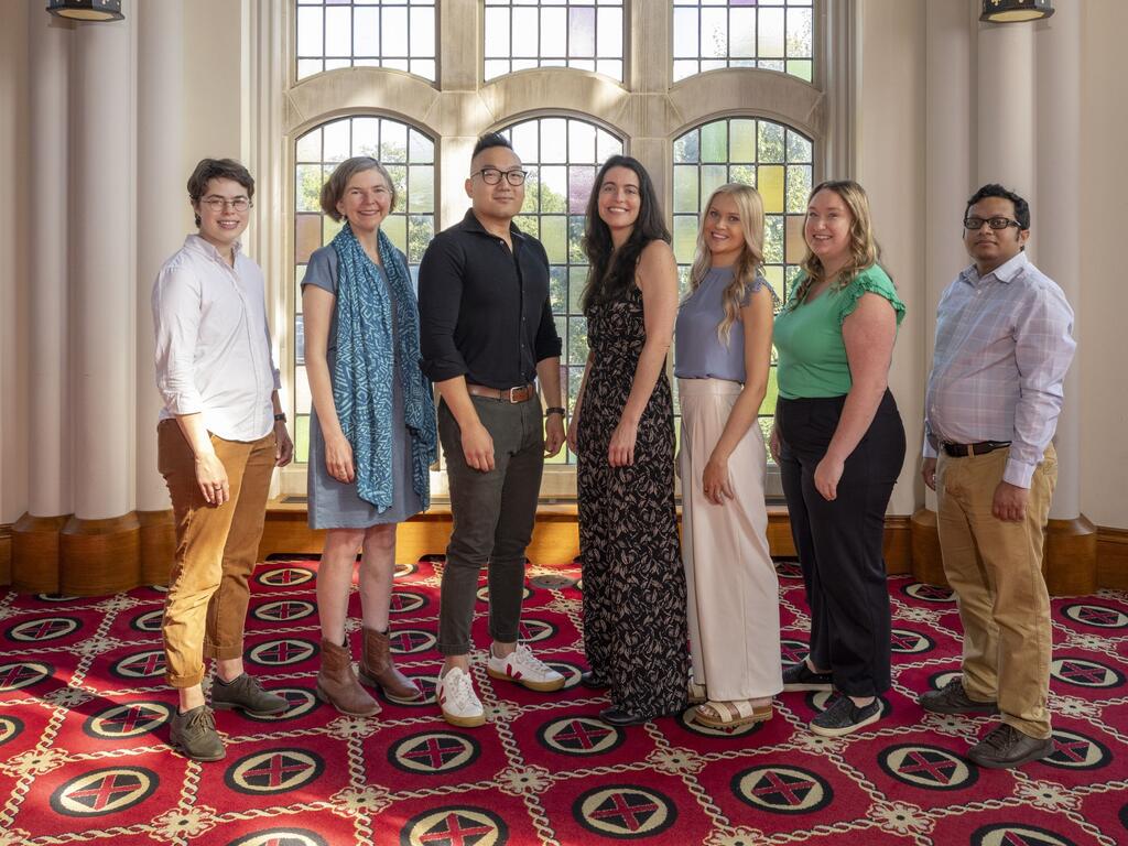 group photo Rhodes College new faculty standing in front of stained glass windows