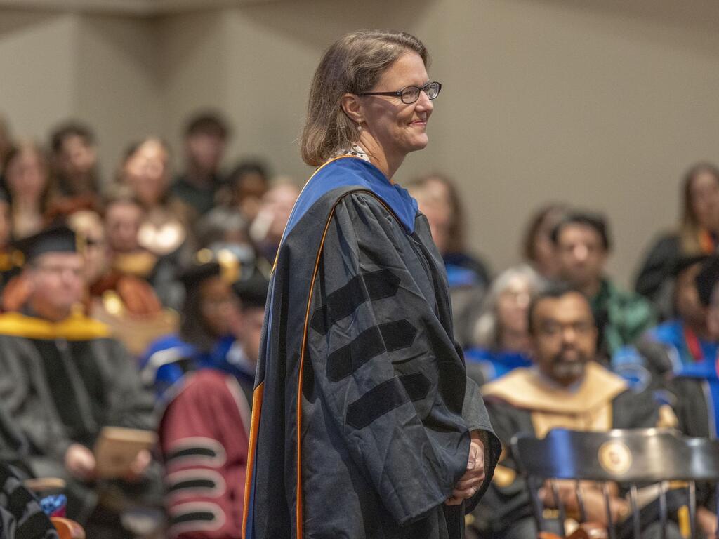 image of Susan Satterfield on the stage in front a faculty audience