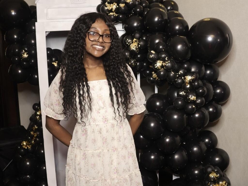 image of Adaria Crutcher standing in front of balloons