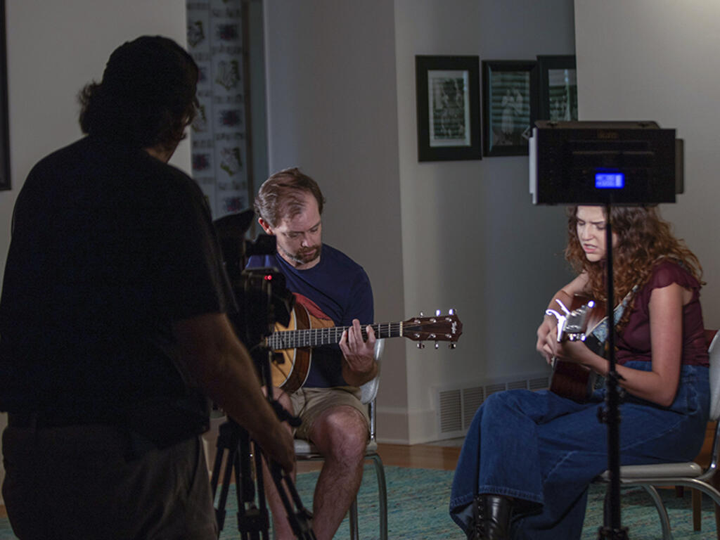 image of Curb staff and students playing the guitar