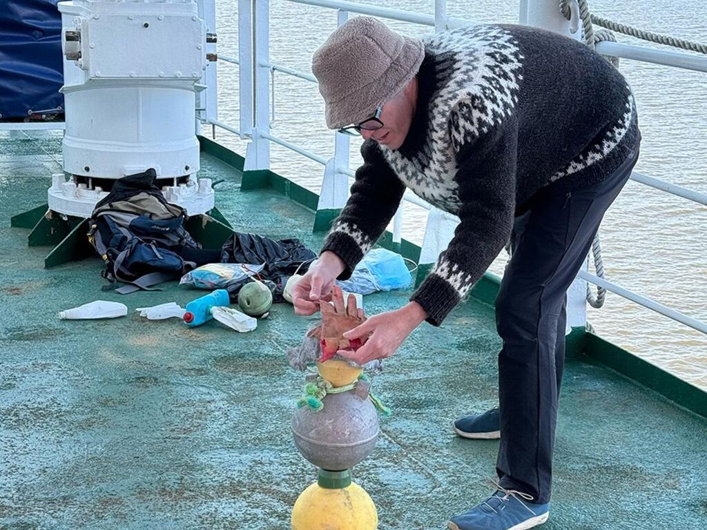 image of Karl Erickson on a boat, working on a sculpture