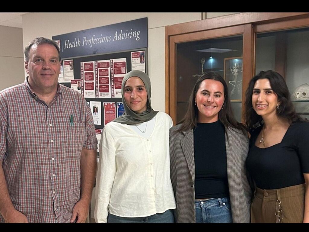 group photo of Prof. Stephen Ceccoli, a student, and guests