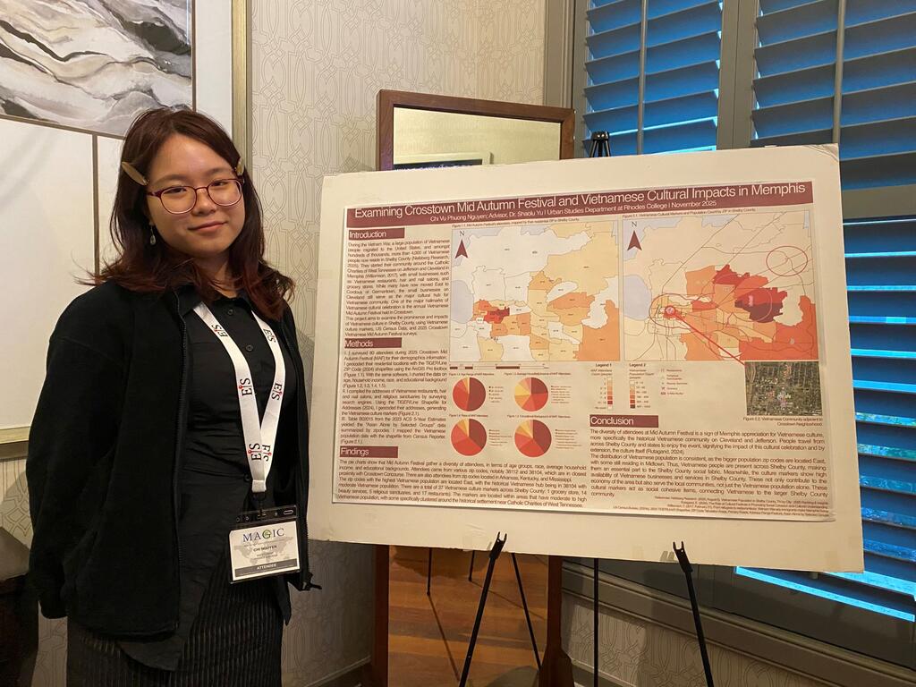 image of student Chi Nguyen standing in front of a poster with information about her project