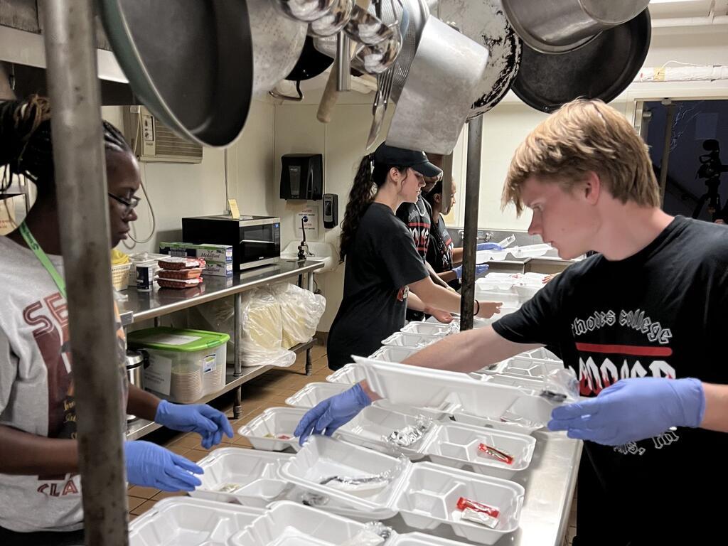 image of Rhodes students preparing food at its soup kitchen