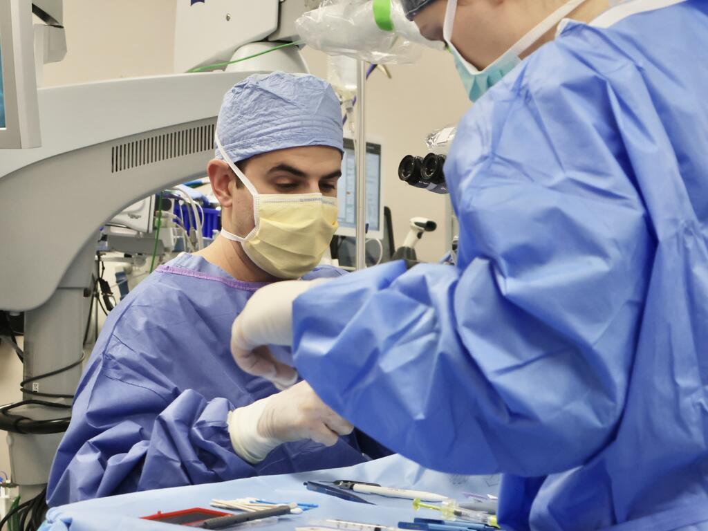 image  of Dr. Salar Rafieetary in scrubs, handling surgical instruments