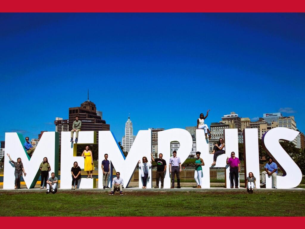 image of Rhodes College students standing around a Memphis sign