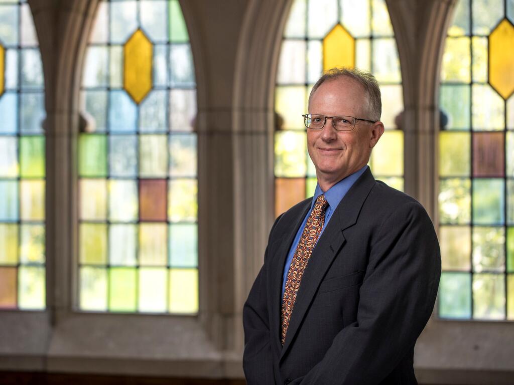 image of Geoff Bakewell in front of a stained glass window