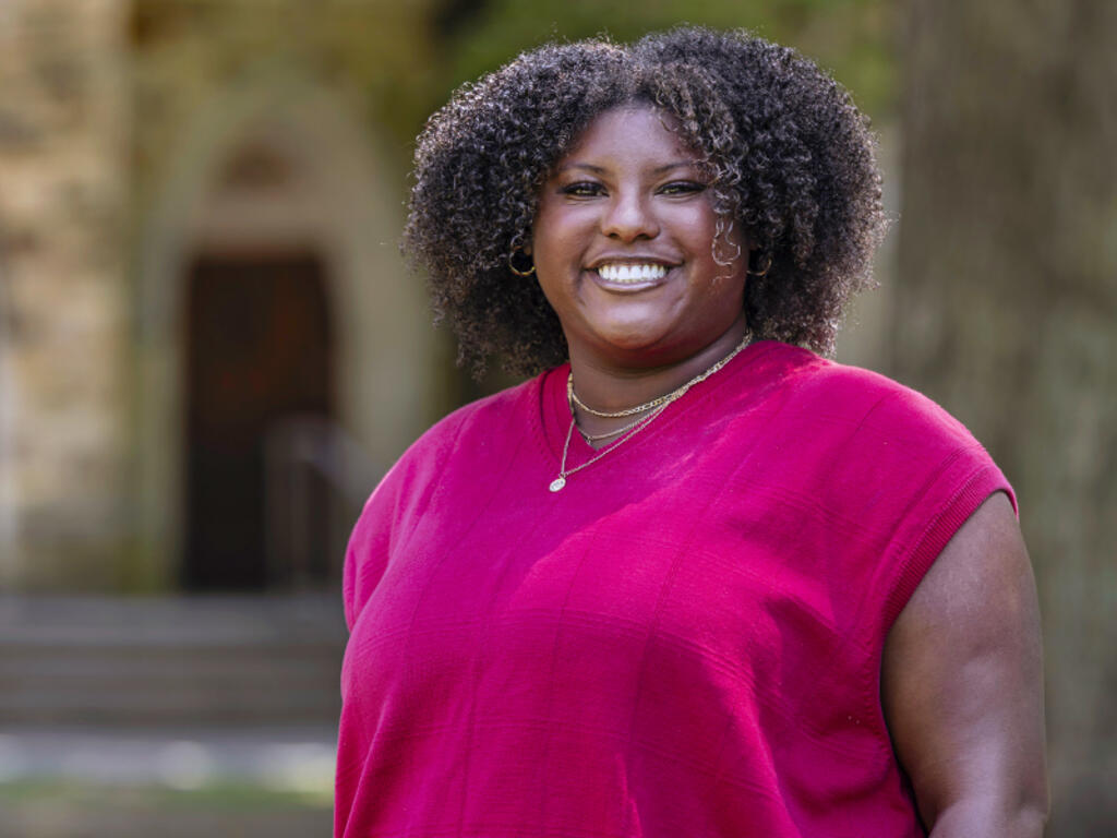 image of Rachel Carroll standing outside on Rhodes campus
