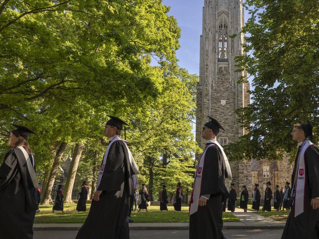 image of Rhodes College graduates walking across campus