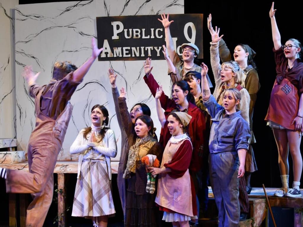 image of theater cast members performing 