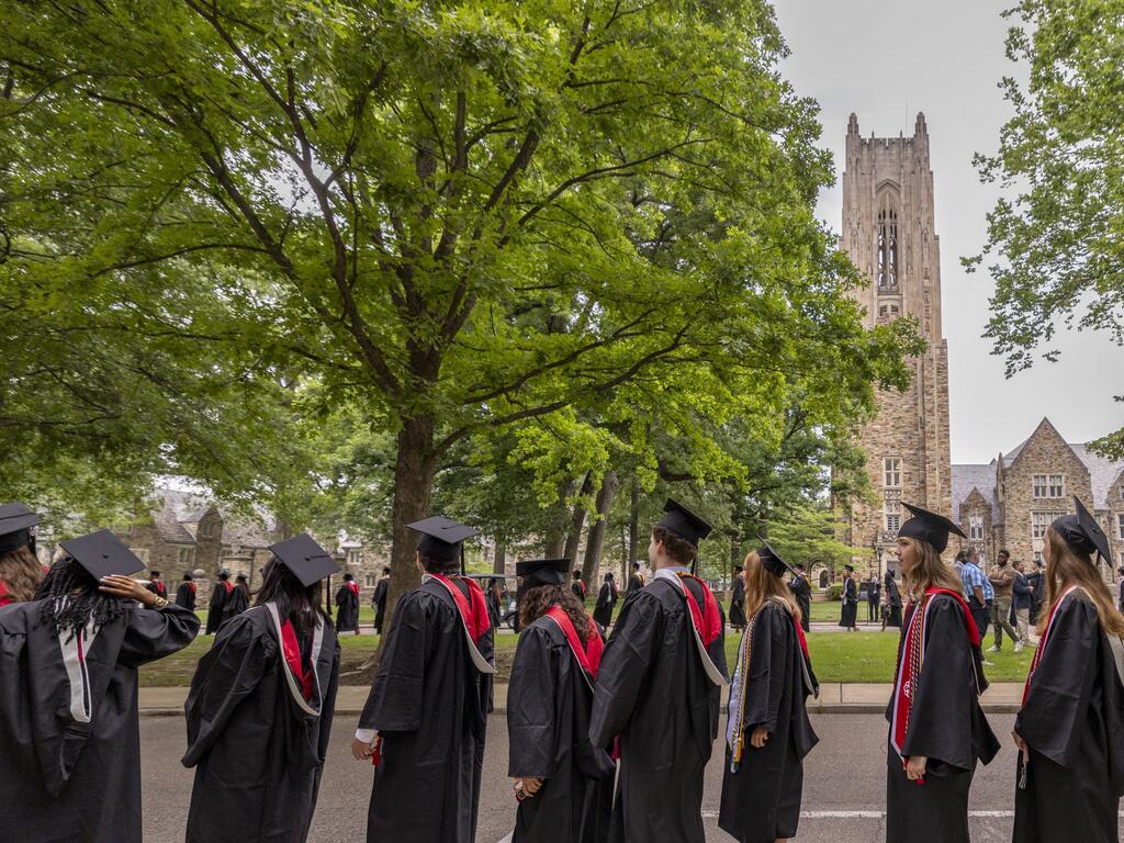 image of Rhodes College graduates walking across campus