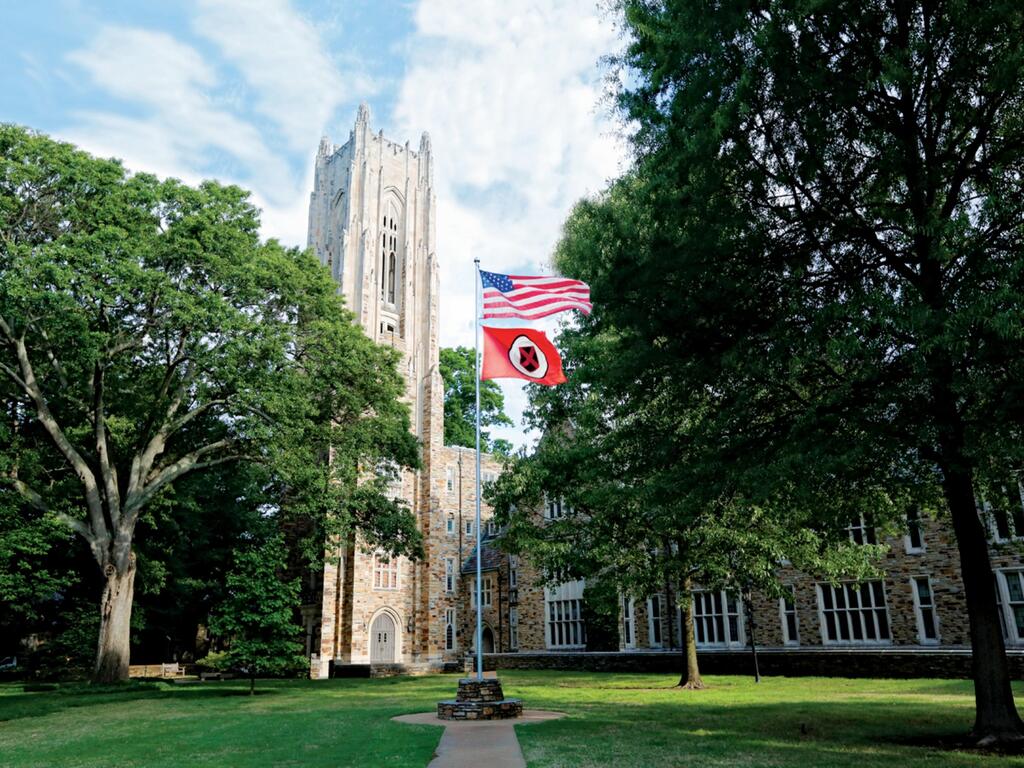 image of flags in front of Rhodes College's Halliburton Tower